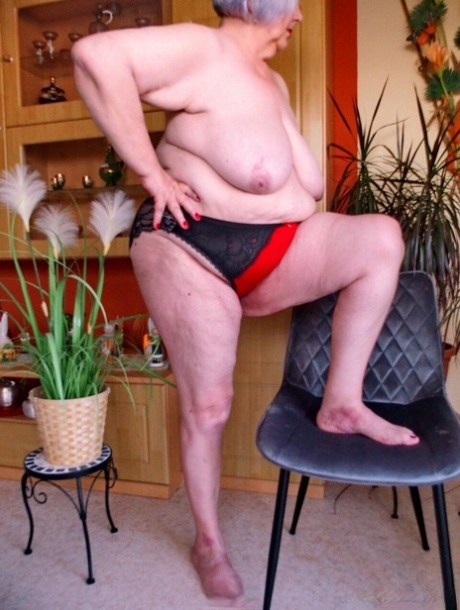 Cute granny with red lipstick Melichora unveils her big saggy tits & flat ass